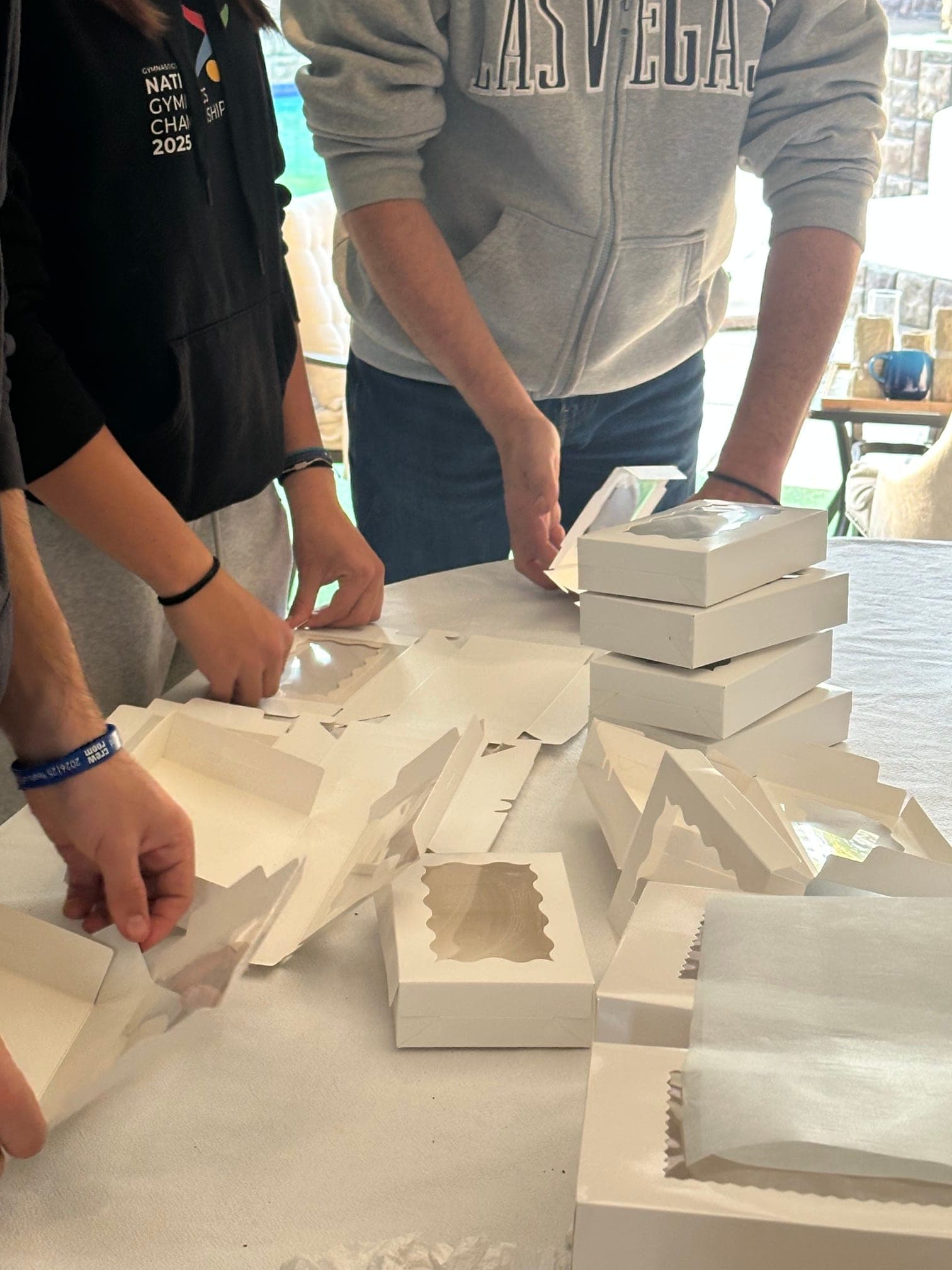 The Klio Kefi family hand-packing boxes of Greek biscuits