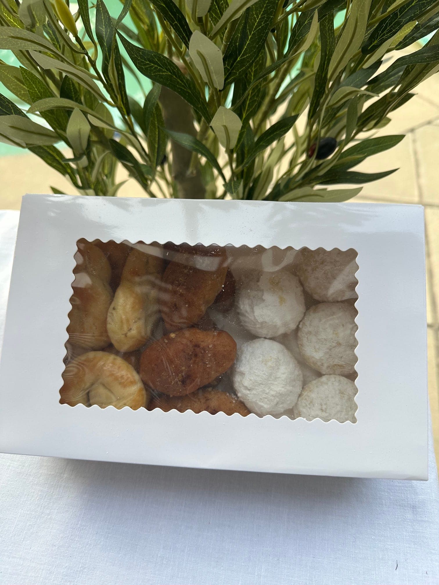 A box of freshly baked Klio Kefi Greek biscuits with an olive branch